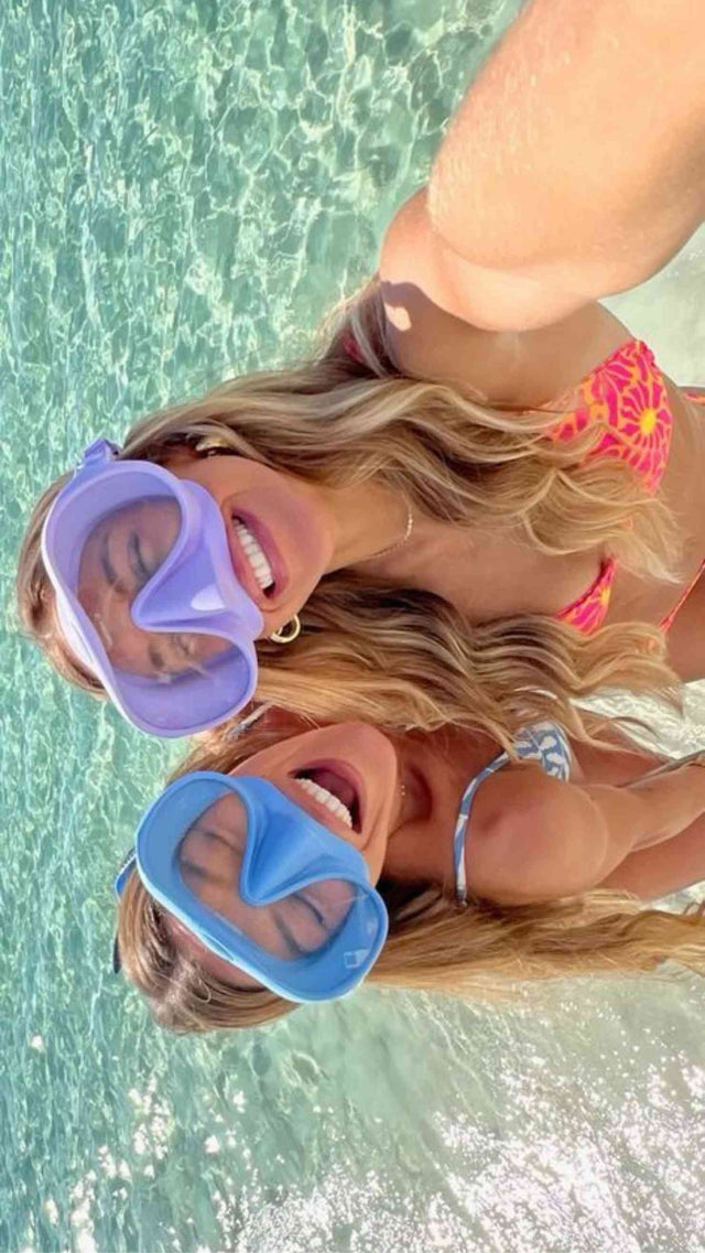 two girls taking picture with dive masks on