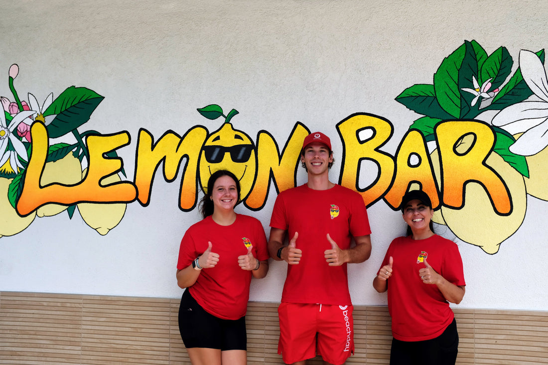Beachday team with Lemon Bar staff in front of the Lemon Bar mural during the Beachday Rewards launch in Neptune Beach, Florida.