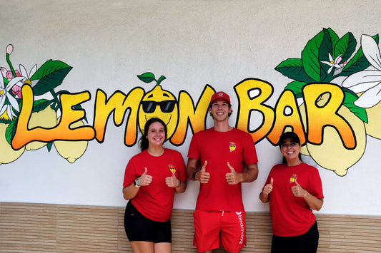 Beachday team with Lemon Bar staff in front of the Lemon Bar mural during the Beachday Rewards launch in Neptune Beach, Florida.